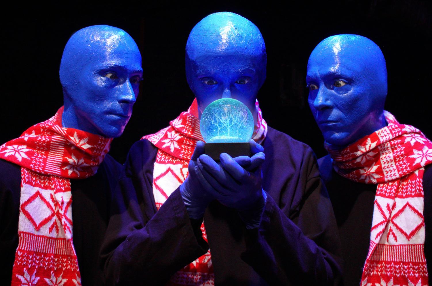 Blue Man Group members use a snow globe during their show.
