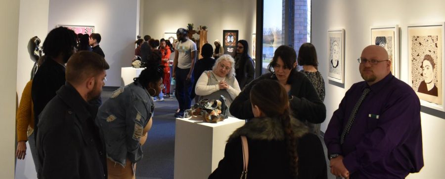 Show goers admire works of the Fine Arts students.