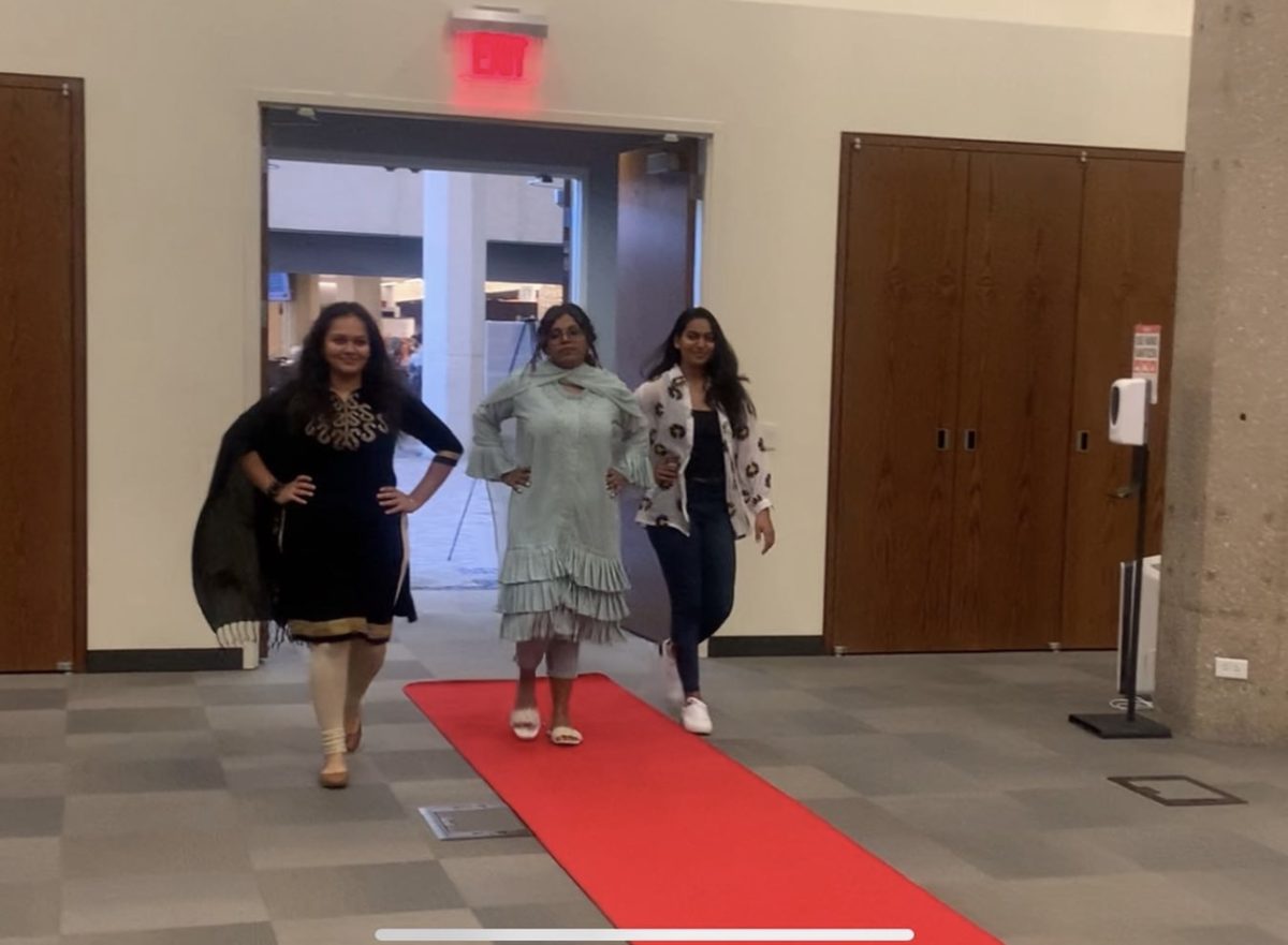 International students walk the red carpet at the fashion show.