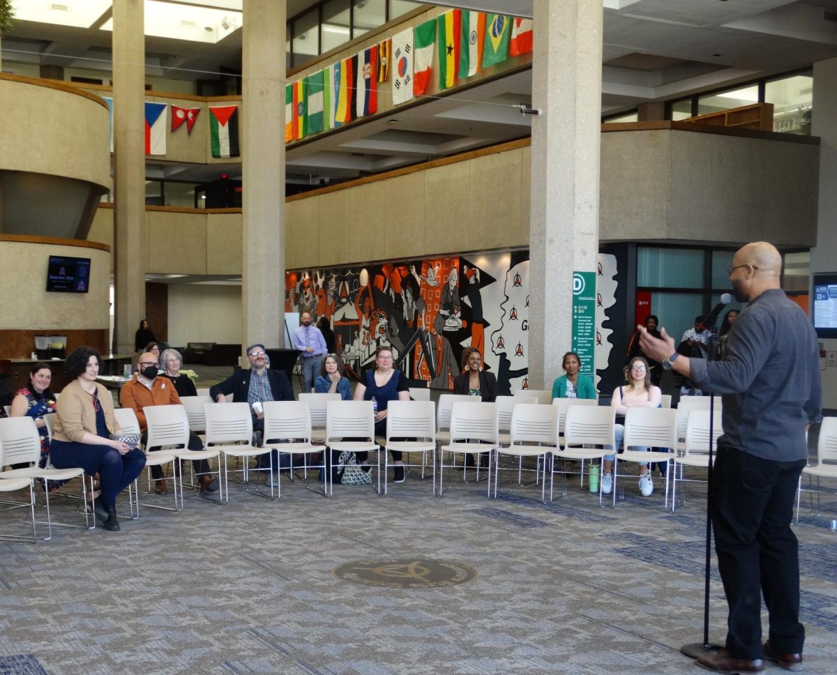 Shannon Cason addressing the First Voice Story Slam audience in the Hall of Governors