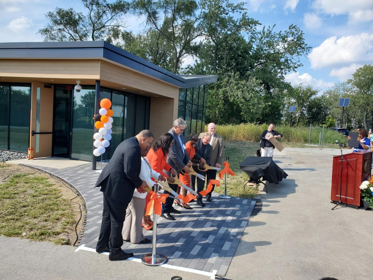 From left: Corey Bradford,  Trustee Stacy Crooks, Cheryl Green, Trustee Jim Kvederas, Phyllis West, John Potempa, and Dominick Demonica cut the ribbon outside the new Social Justice Building.