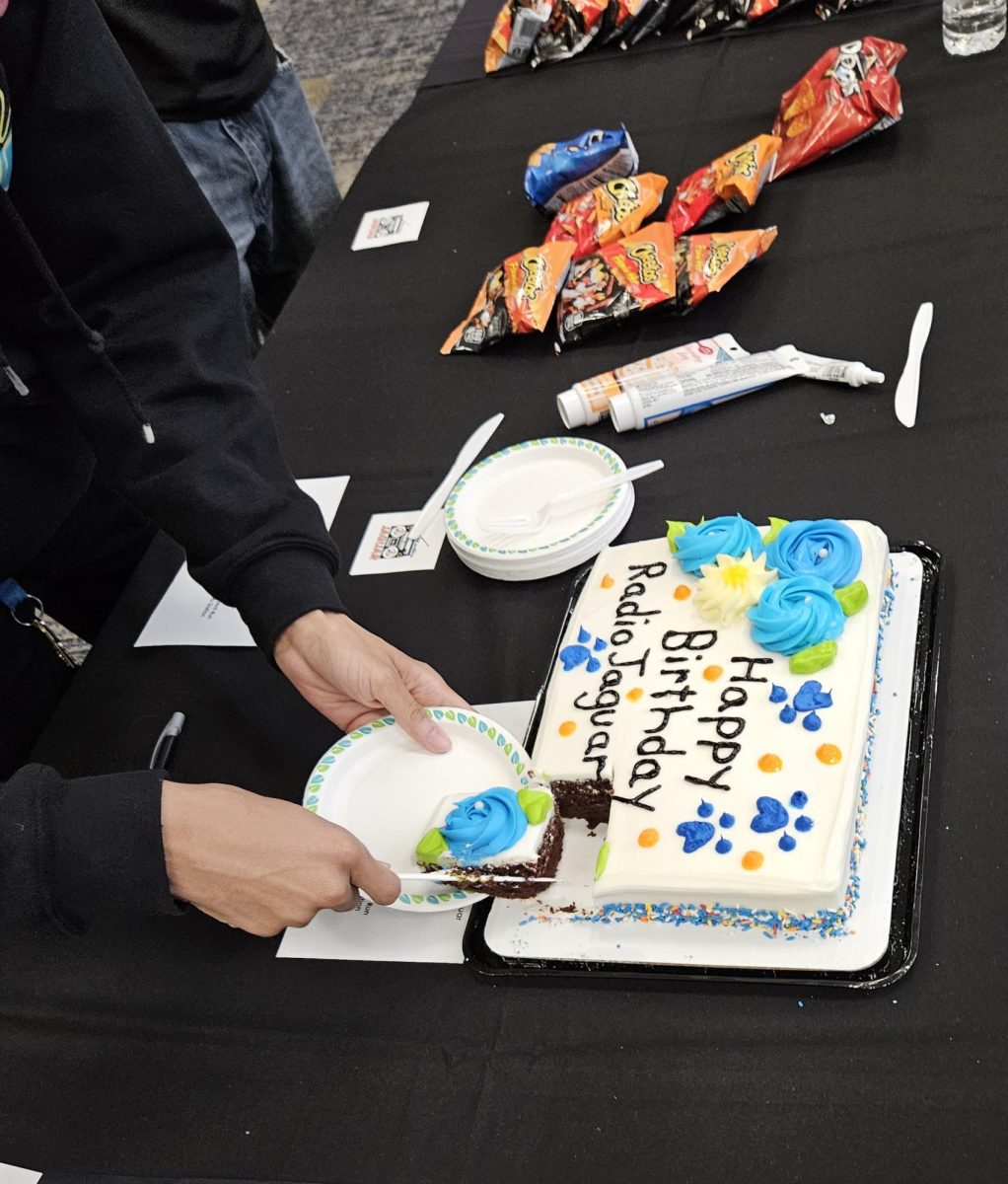 Students enjoying the Radio Jaguar birthday cake.