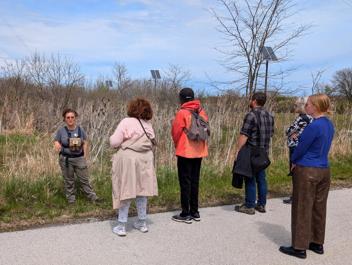 Negin Almassi from Cook County Forest Preserves speaks to community members during a guided sound walk.
