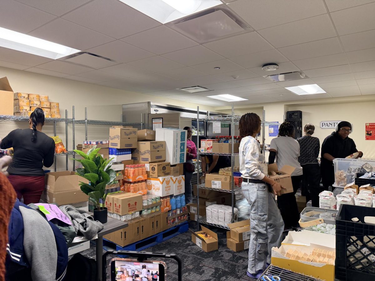 Volunteers work together during the Feed the Future, Honor the Past initiative on Feb. 19 in Room B1242, organizing and restocking supplies at the GovState Food Pantry to support campus food accessibility efforts.