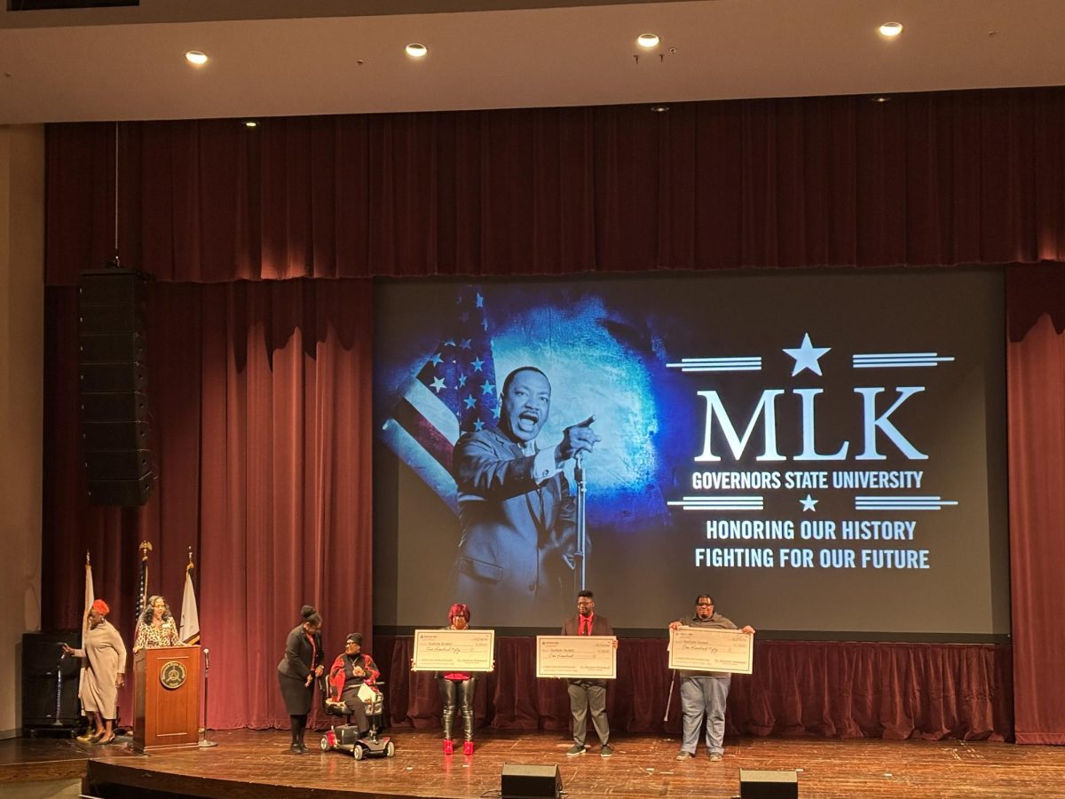 MLK Writing Contest winners hold their checks (right to left),  Gail Rutherford, Timotheus Gordon and Glenford Flowers.