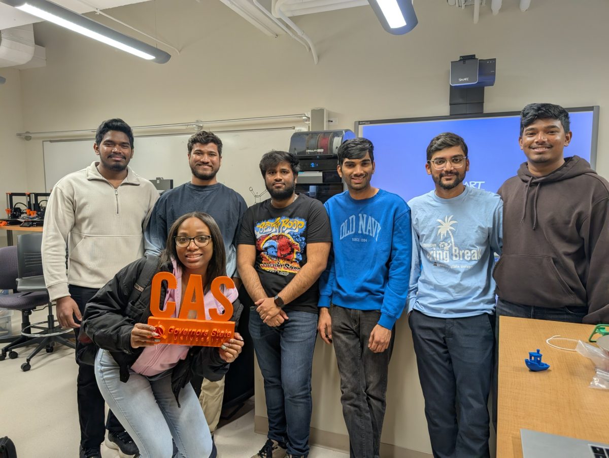 Members of the Innovation Club demonstrate 3D printing during a hands-on session at Governors State University, where students printed multiple designs live in preparation for a fundraising event.