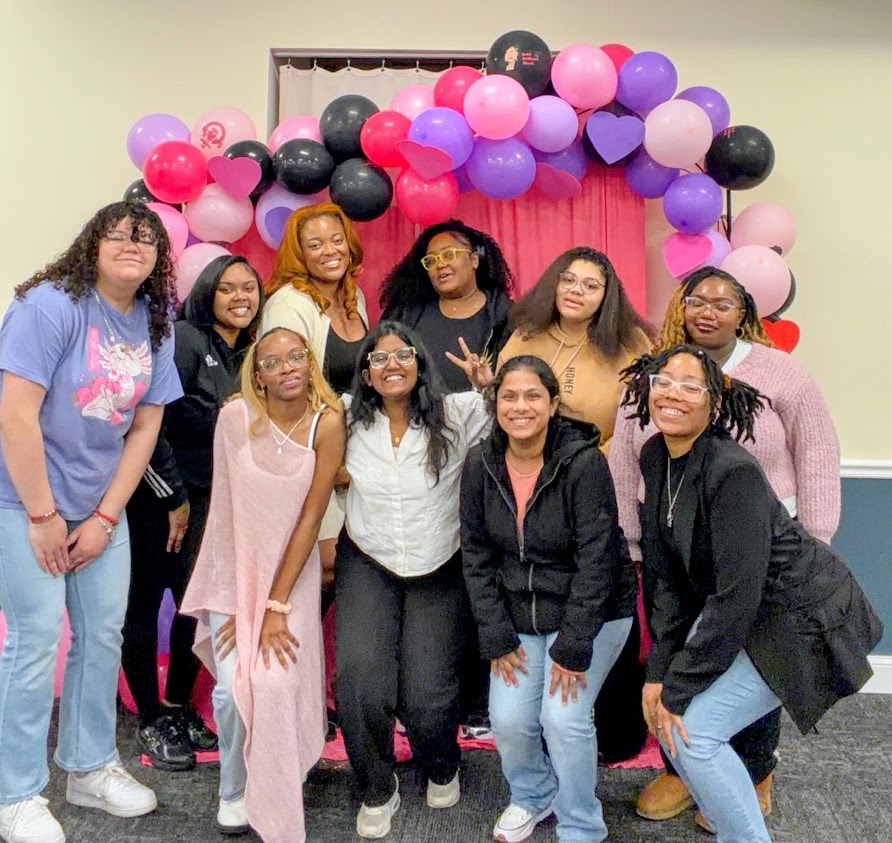 The Glow & Grow: Self-Love Social event celebrates Women’s History Month with a vibrant balloon backdrop in the Hall of Honors at Governors State University.