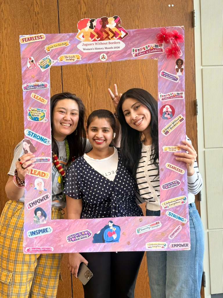 Students capture fun moments at the “Women Around the World” photo booth during the Women’s History Month celebration.