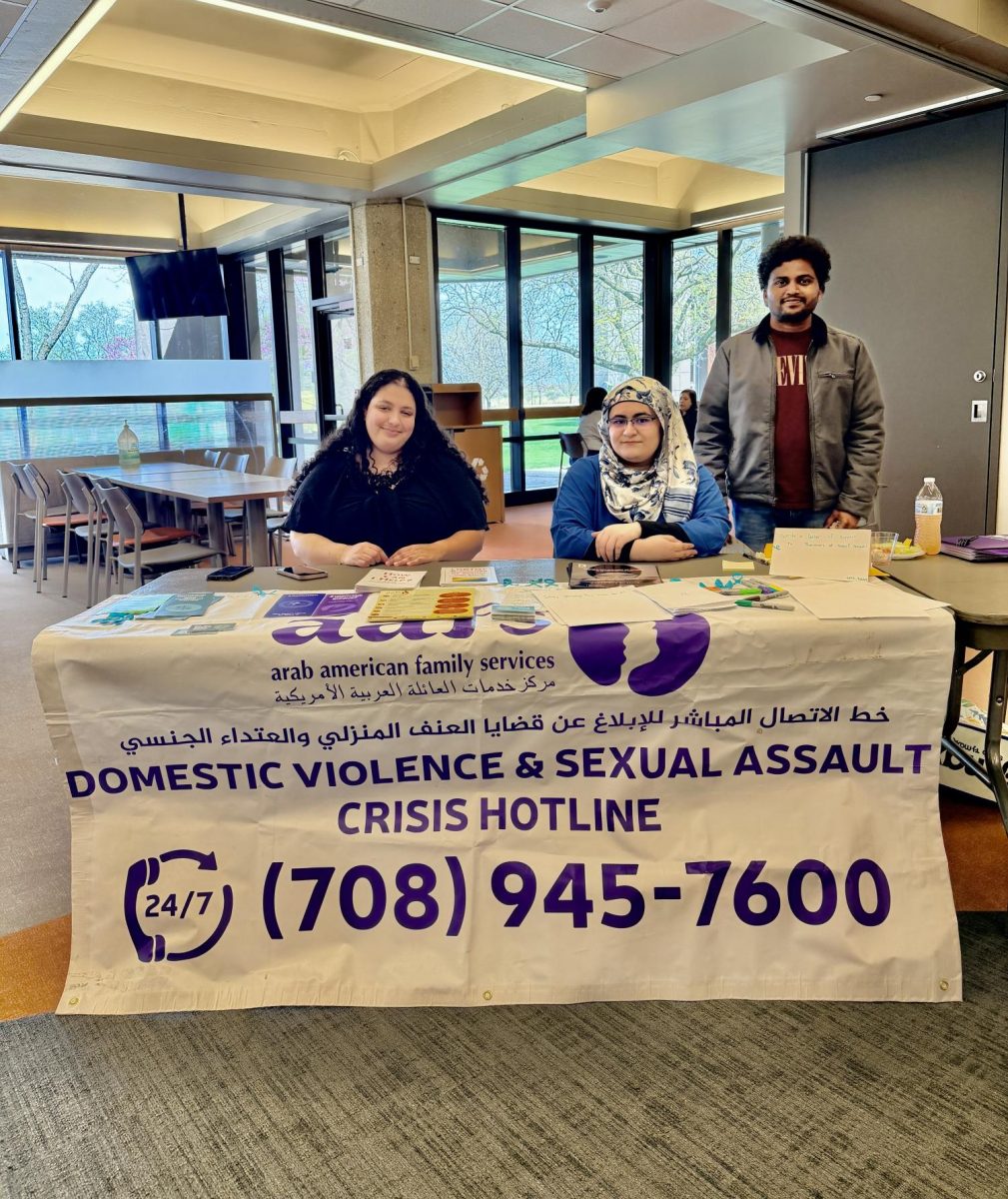 Informational brochures on domestic violence awareness highlight warning signs and support resources during a campus event.