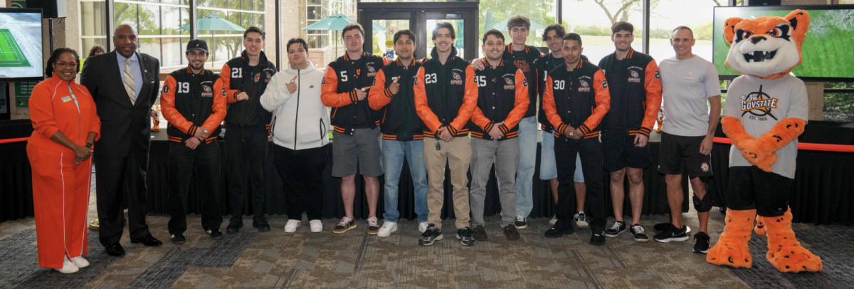 Honored members of the soccer team along with atheltic director Tony Bates, and president Dr. Ester. 